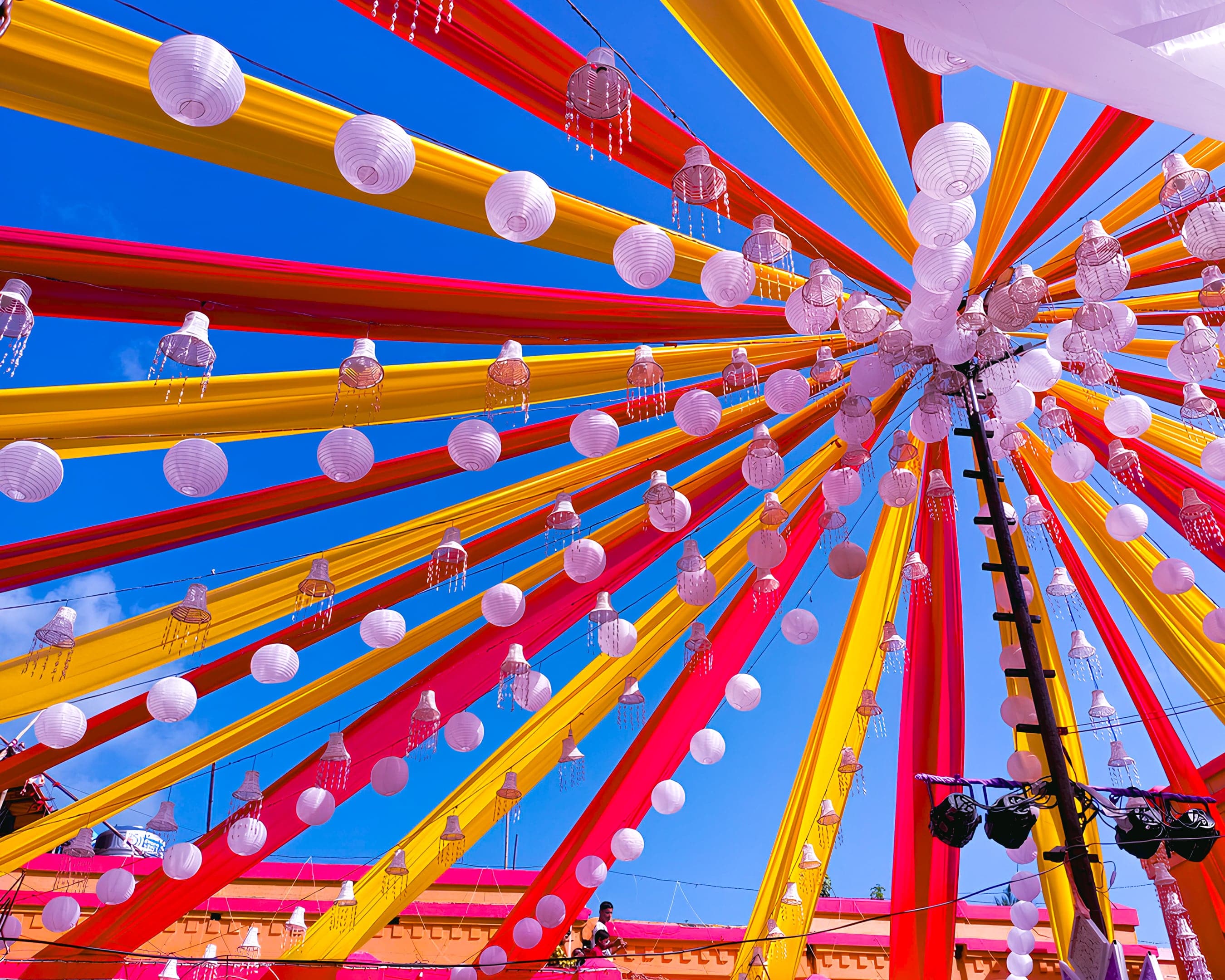 A colorful decoration with chinese lights hanging from it.
