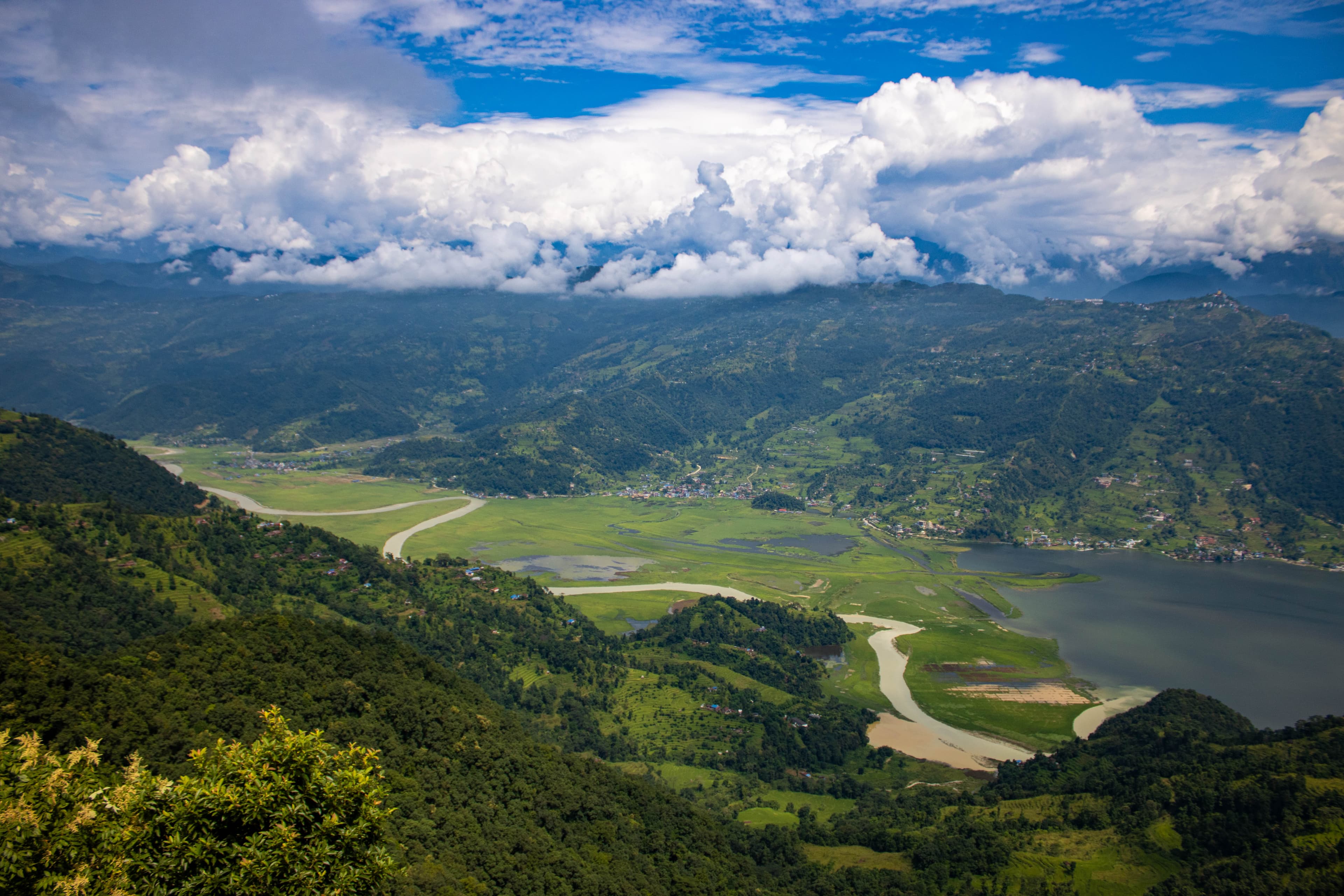 A stunning aerial view of Pokhara Valley, Nepal—where winding rivers and emerald hills meet beneath the Himalayan sky.